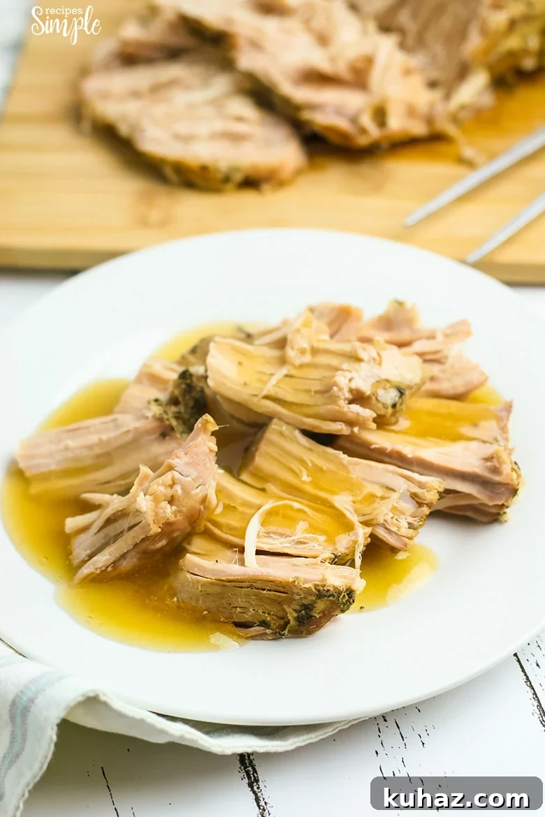 Slow Cooker Pork Tenderloin with Savory Gravy 2 Pork Tenderloin with Gravy poured over it on white plate