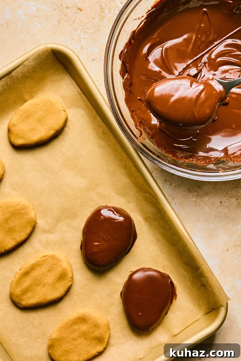 dipping homemade reese's eggs in chocolate.