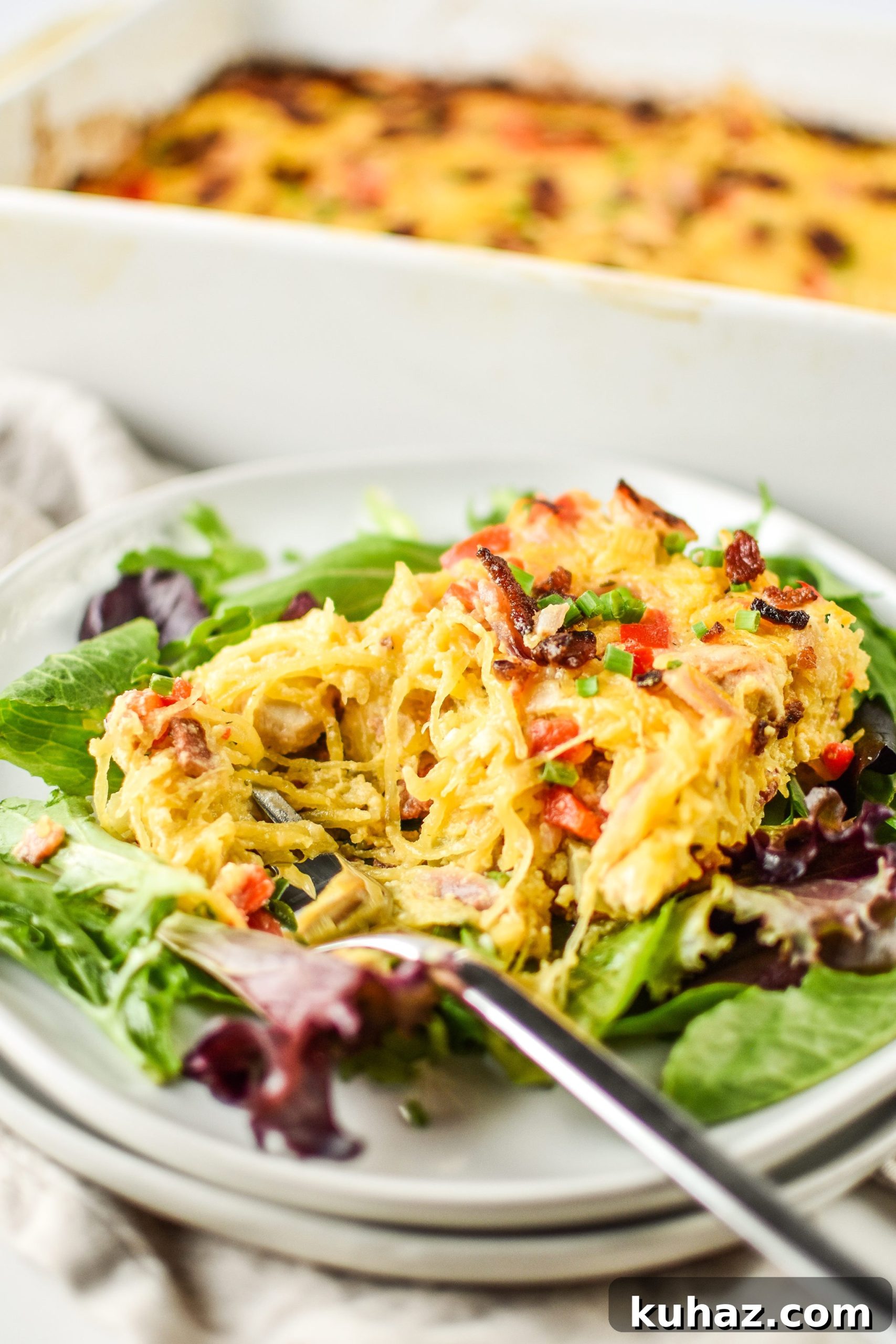 Whole30 Chicken Bacon Ranch Casserole Recipe 9 A plate of Whole30 Chicken Bacon Ranch Casserole partially eaten with the casserole in the background.