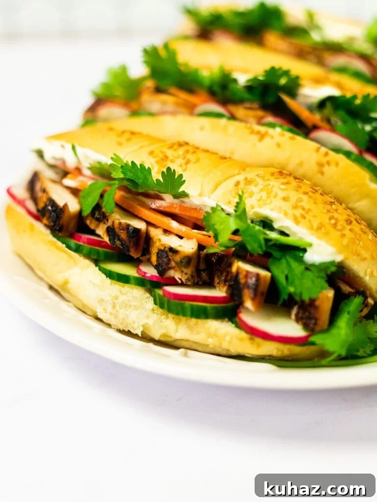 Grilled Chicken Banh Mi Sandwich with Pickled Veggies 8 A side view of a plate of grilled chicken banh mi sandwiches.