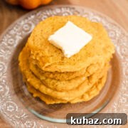 Close-up of a stack of gluten free pancakes with butter on top.