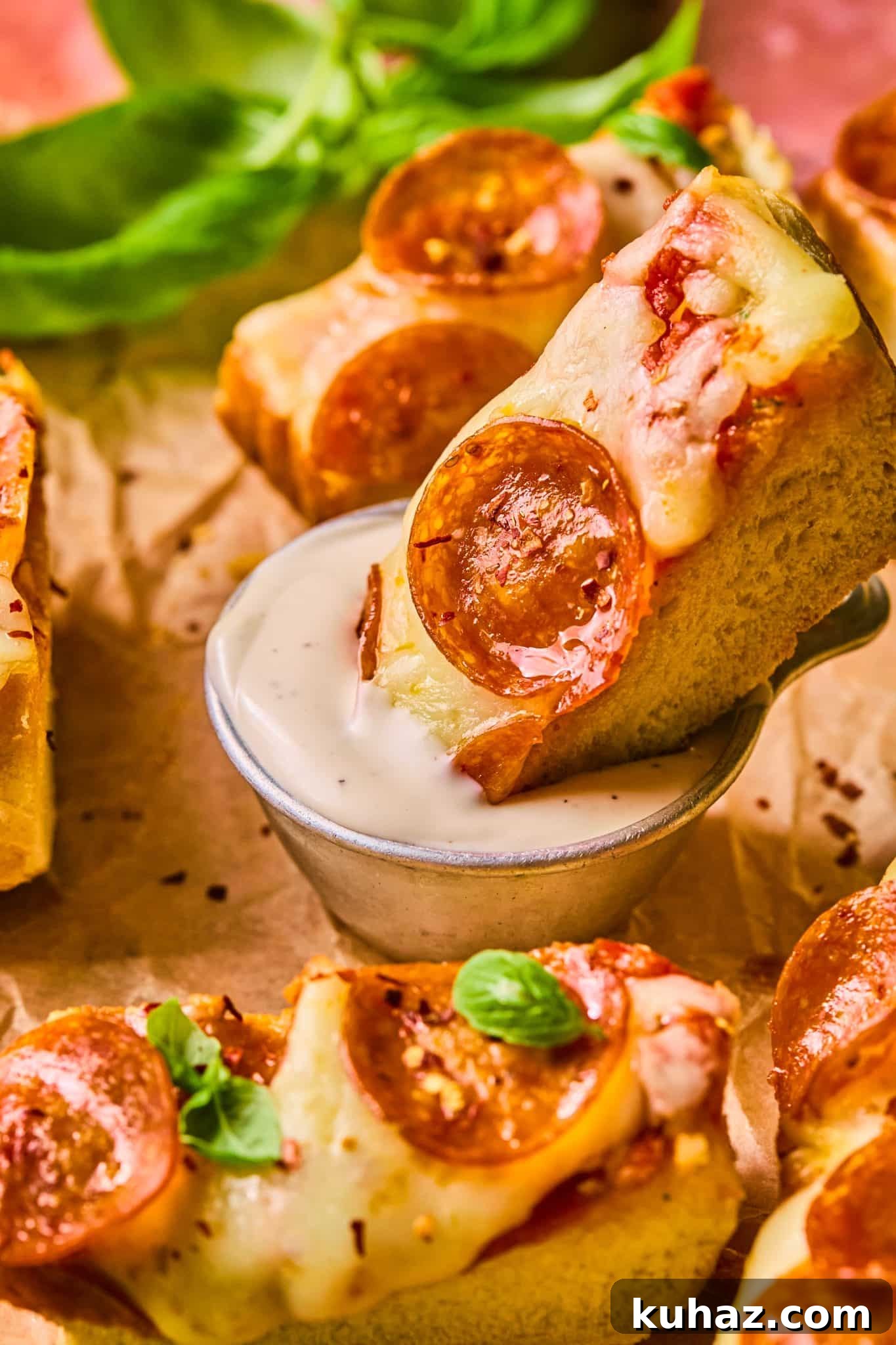 Garlic Bread Pizza Recipe 10 pepperoni pizza being dunked into ranch.