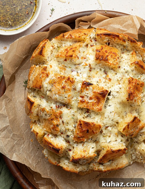 cheesy pull apart bread on serving dip with dipping oil