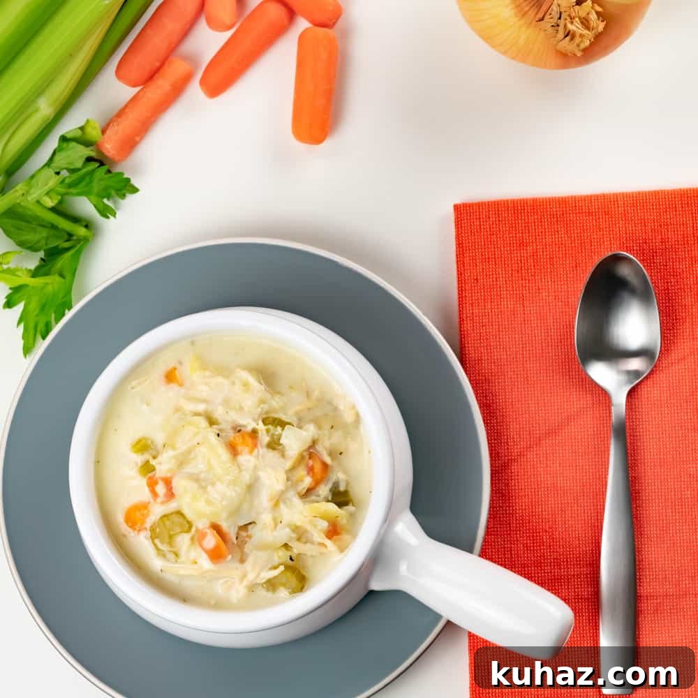 Instant Pot Chicken Tortellini Soup in white bowl with handle and orange napkin Instant Pot Chicken Tortellini Soup in white bowl with handle and orange napkin.