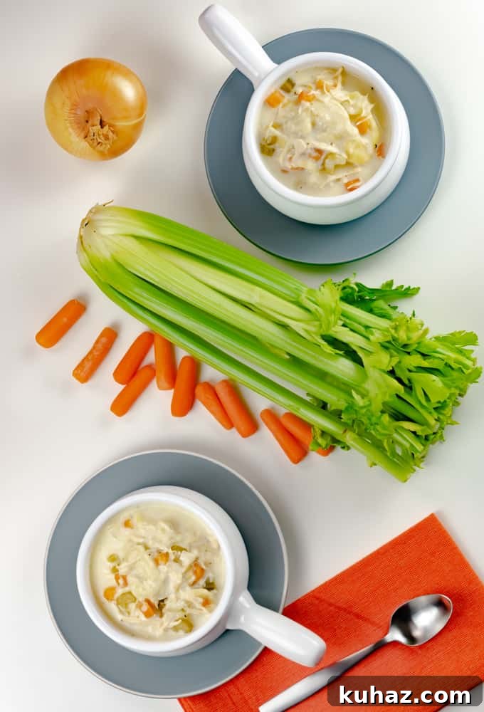 Instant Pot Chicken Tortellini Soup in white bowl with handle and orange napkin Instant Pot Chicken Tortellini Soup in a white bowl with handle and orange napkin.