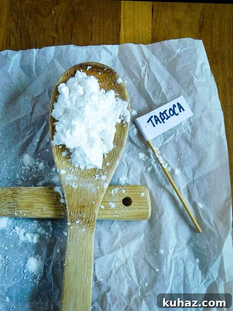 Cornstarch, Tapioca, Arrowroot Compared: Uses and Substitutes 5 tapioca starch on a wooden spoon