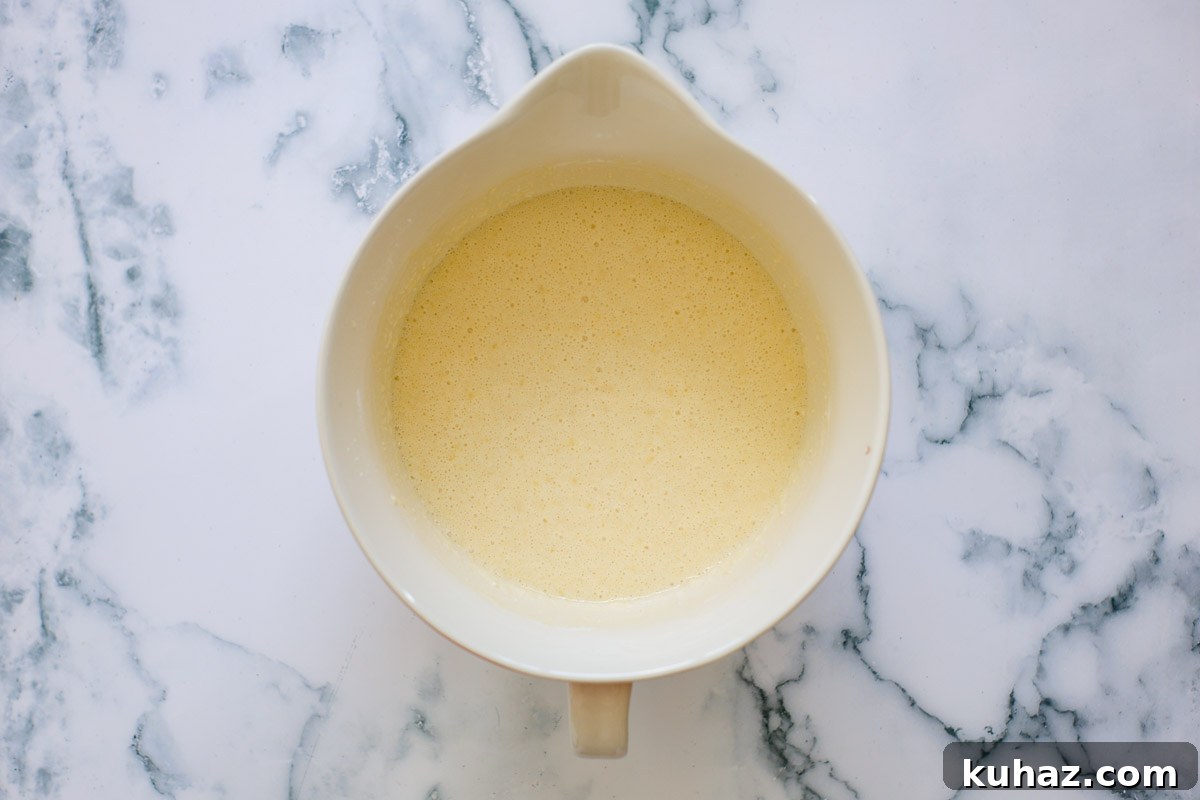 How to Make Sourdough Discard Crepes 6 Crepe batter inside a ceramic bowl.
