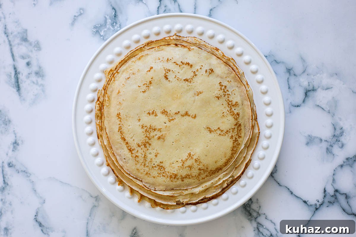 How to Make Sourdough Discard Crepes 8 A stack of sourdough discard crepes, on a plate.