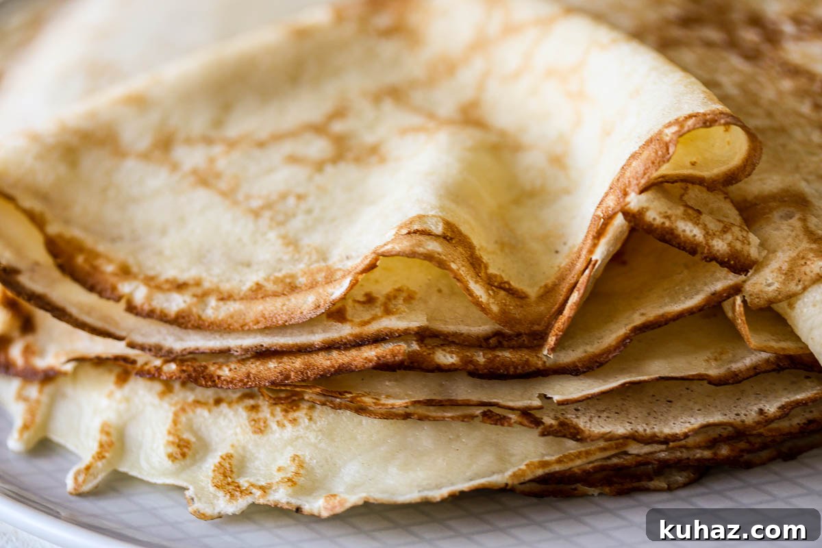 How to Make Sourdough Discard Crepes 9 The edges of a stack of golden crepes.