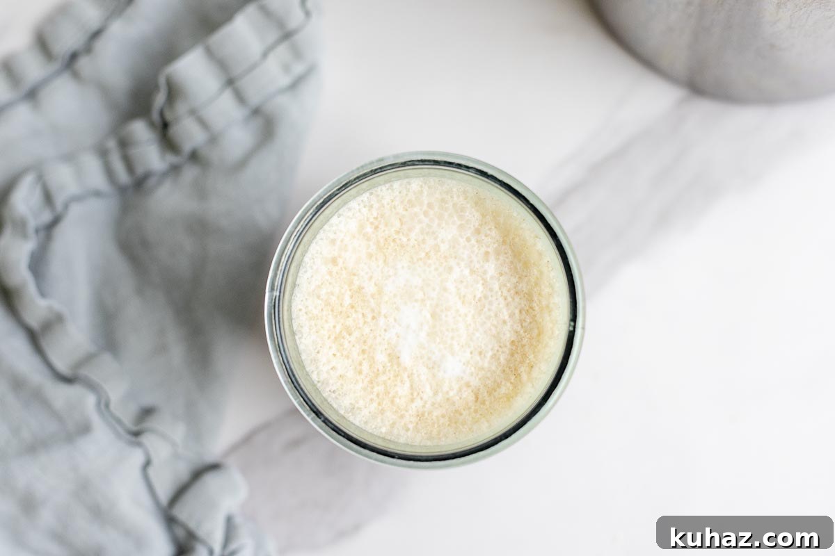 How to Make Sweet Cream Cold Foam at Home 3 overhead photo of cold foam in a glass jar.