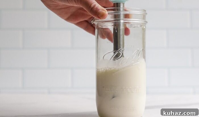 How to Make Sweet Cream Cold Foam at Home 6 frothed milk that has doubled in size in a jar with a immersion blender.