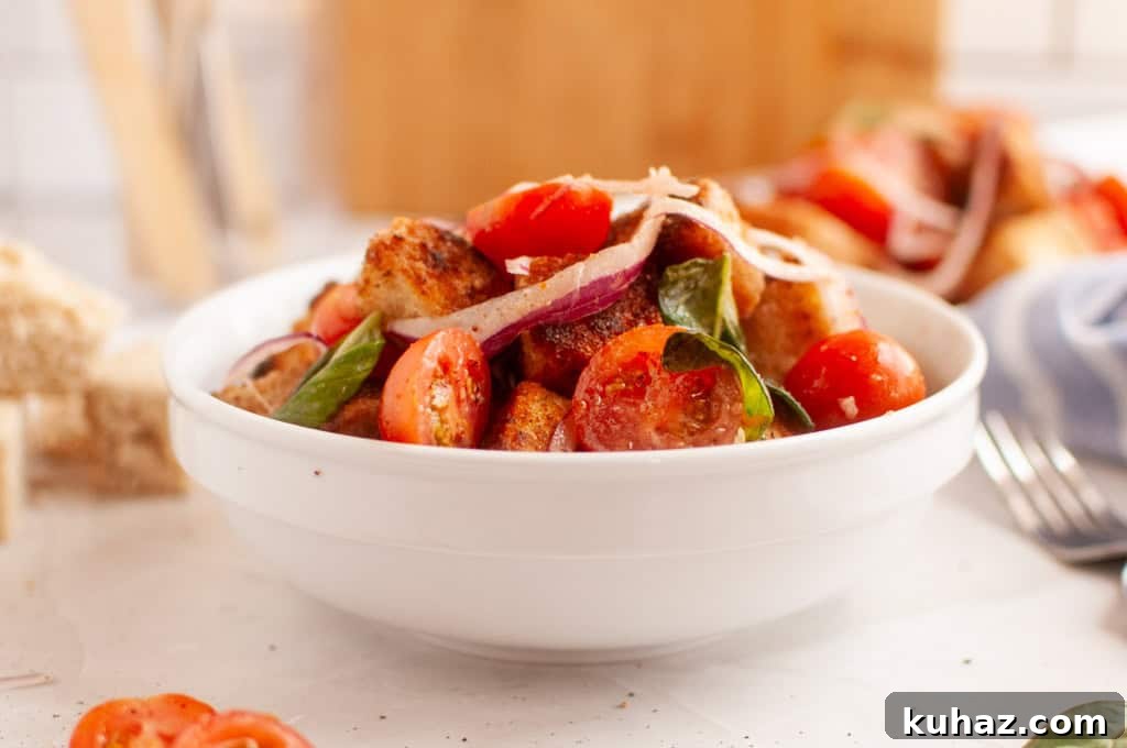 17 Authentic Italian Dinner Recipes Even Nonna Will Love 7 A white bowl filled with Old-Fashioned Panzanella Salad.