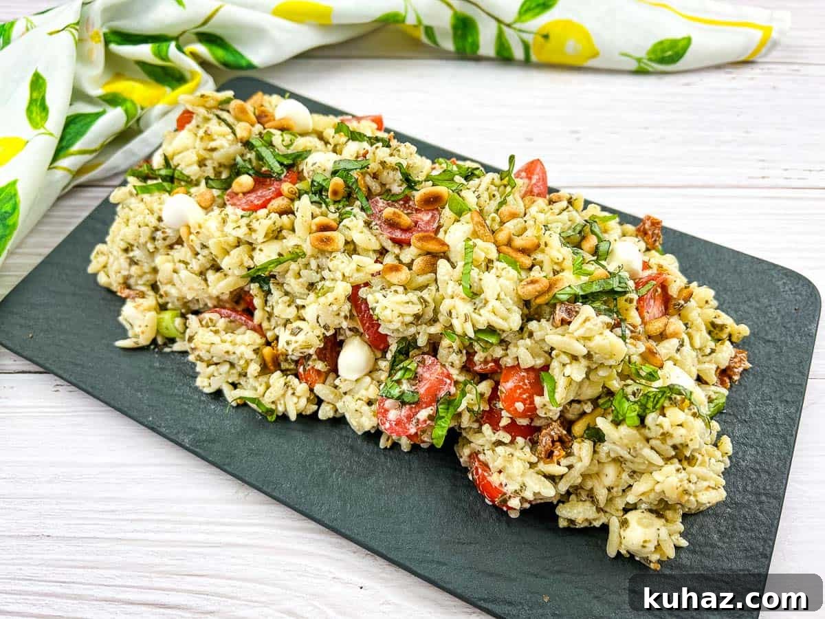 17 Authentic Italian Dinner Recipes Even Nonna Will Love 9 Orzo salad resting on a dark plate.