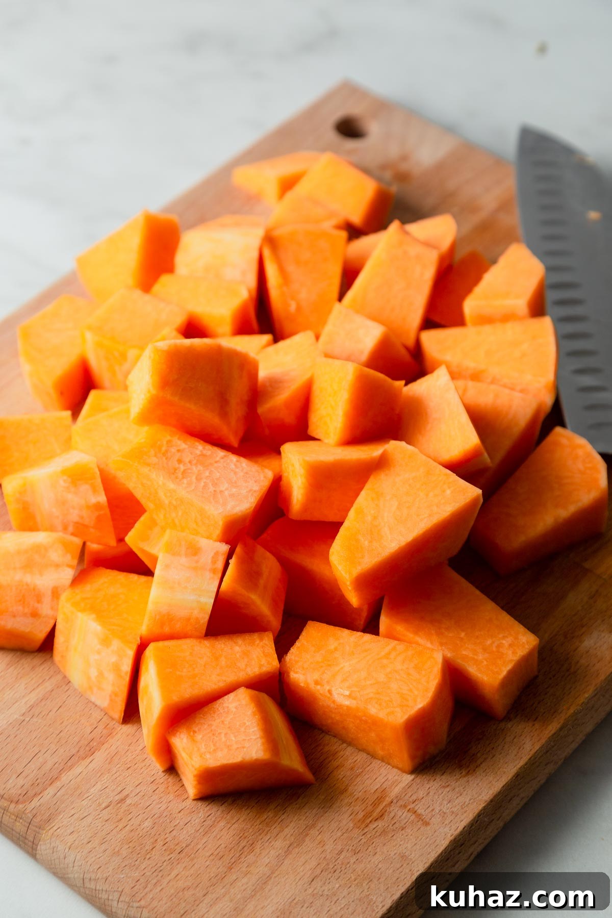 cutting the pumpkin into cubes.