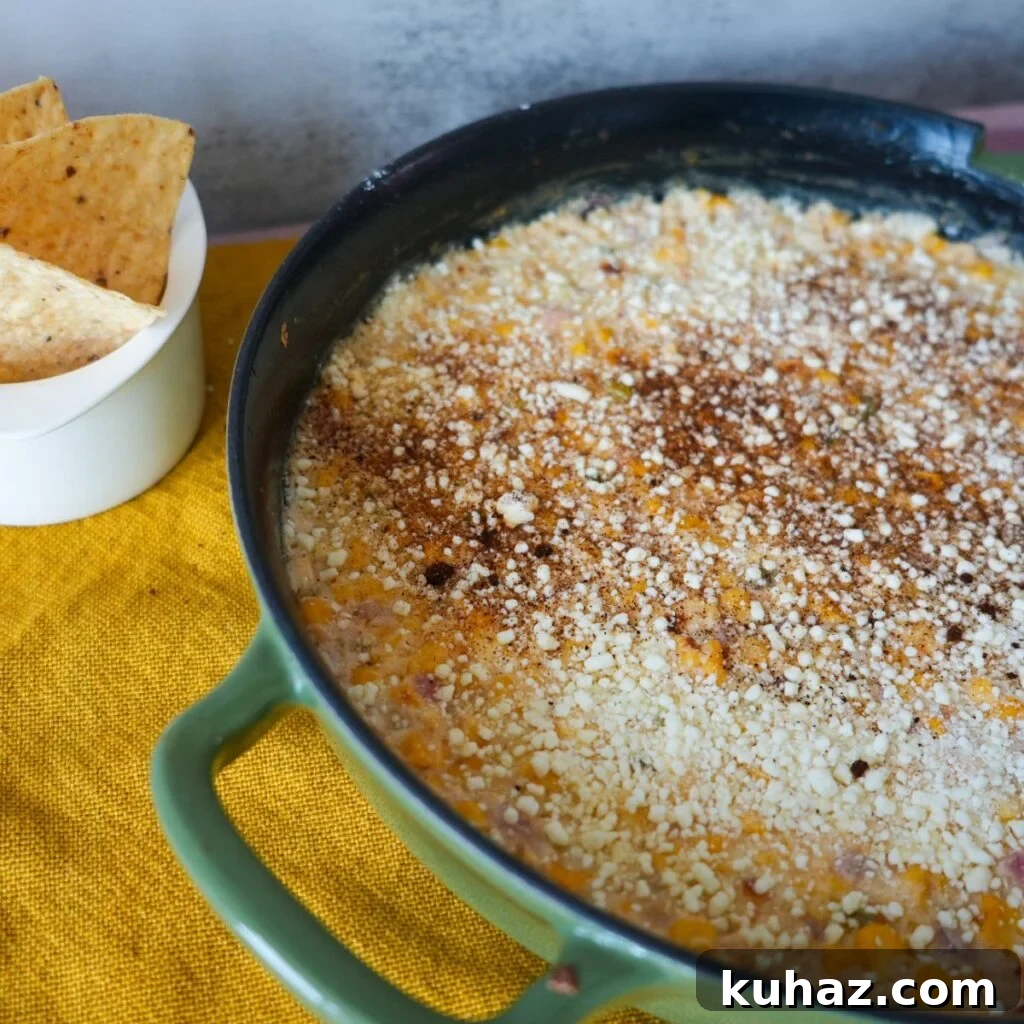 Elote dip fresh from the oven, topped with cotija and spices.