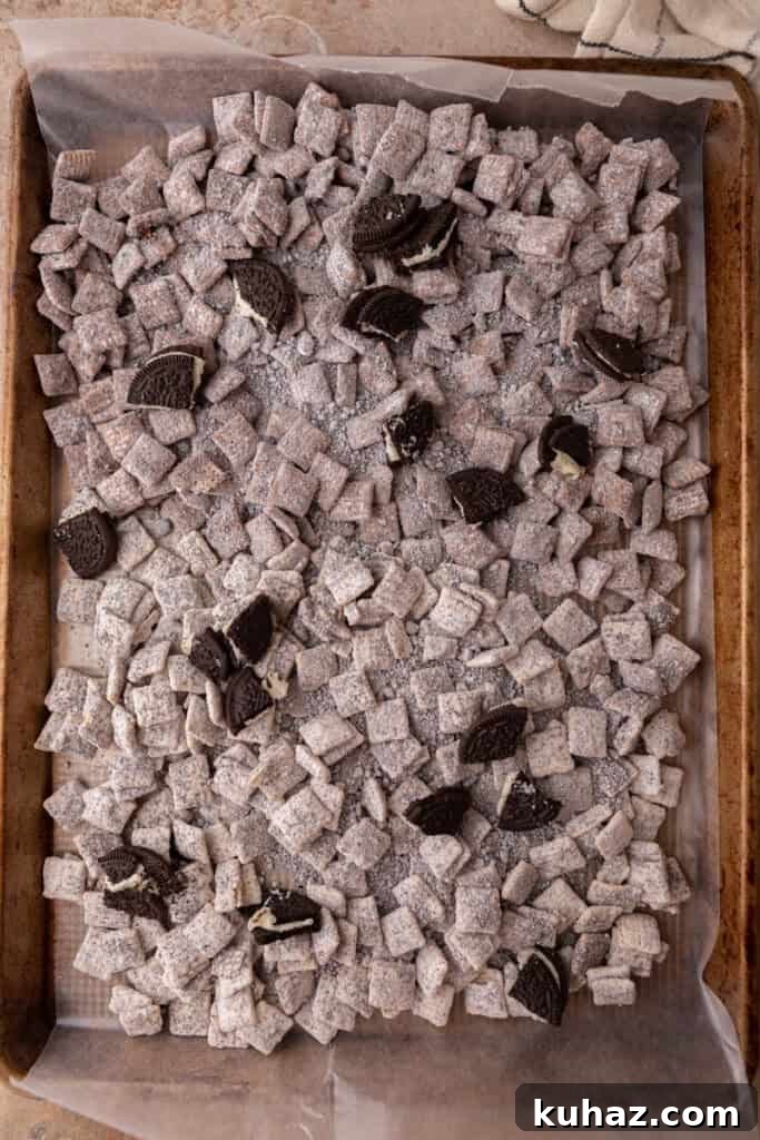 No-Bake Cookies and Cream Muddy Buddies Recipe 9 fully mixed cookies, chocolate and chex on a sheet pan