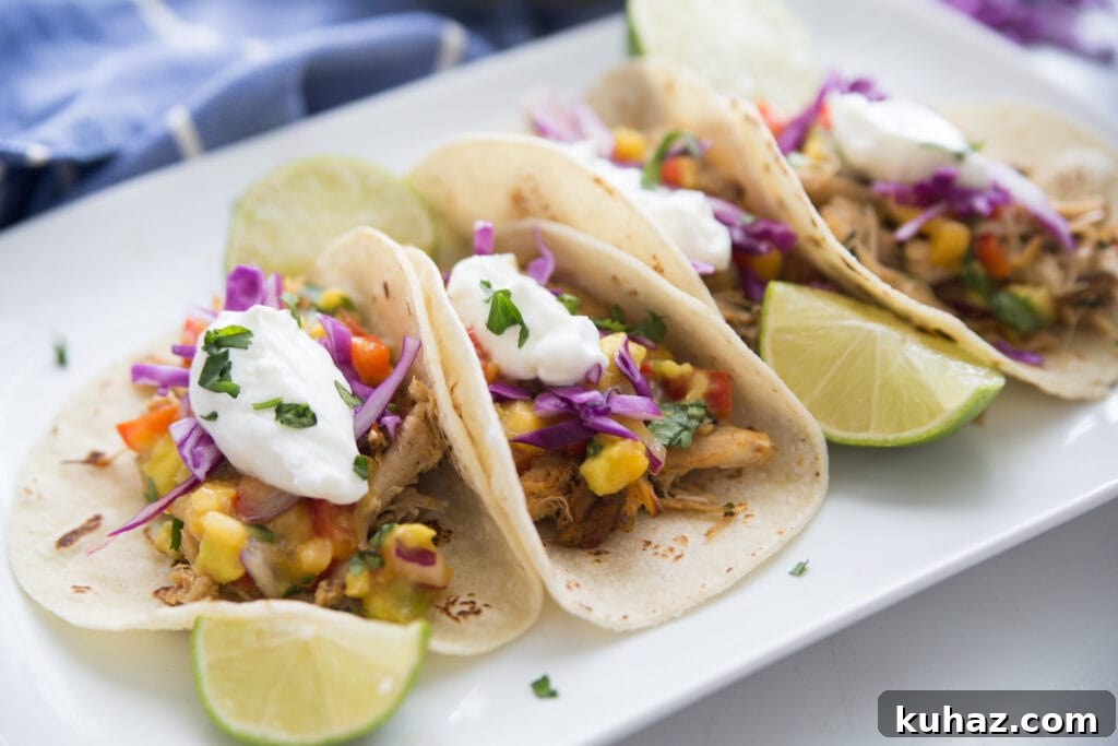 Instant Pot Chicken Carnitas with Avocado Peach Salsa Recipe 3 A plate of instant pot chicken carnitas topped with peach salsa and greek yogurt