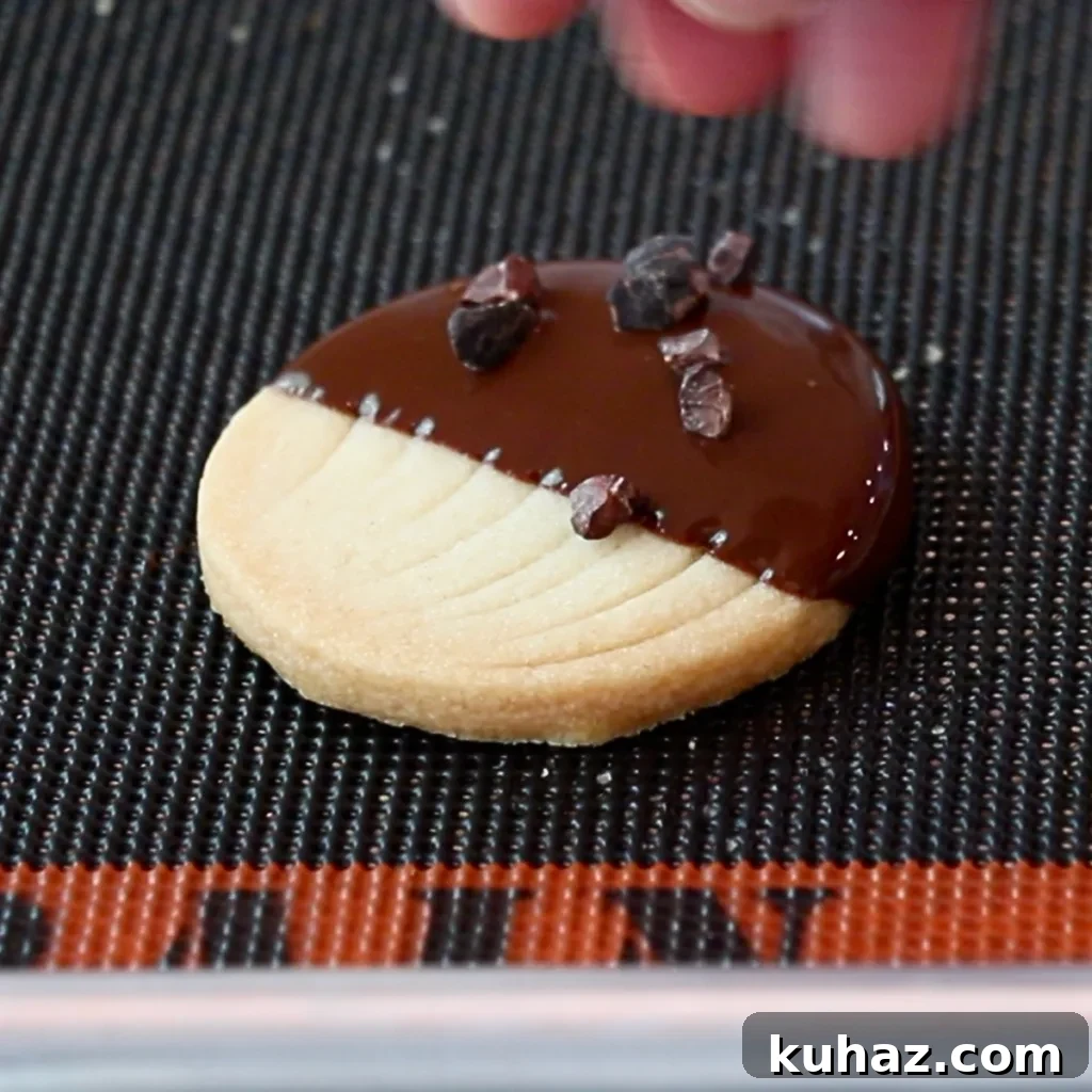 Buttery Classic Shortbread Cookies Recipe 20 sprinkling cacao nib on top of dark chocolate on a cookie