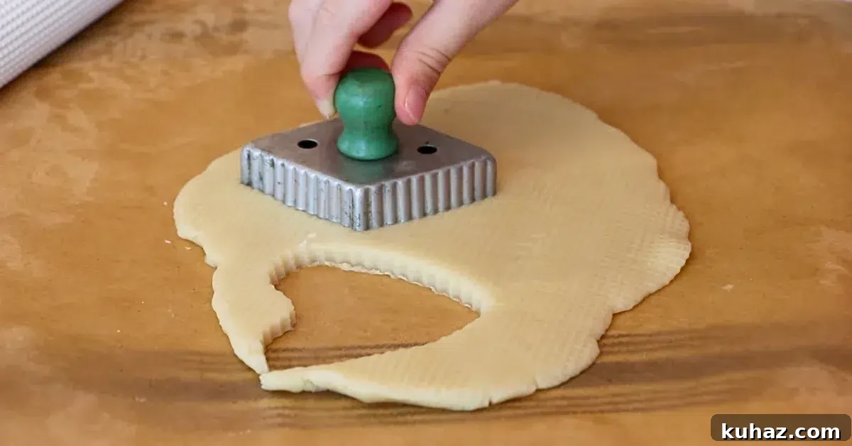 Buttery Classic Shortbread Cookies Recipe 6 cutting cookie dough with a vintage cookie cutter.