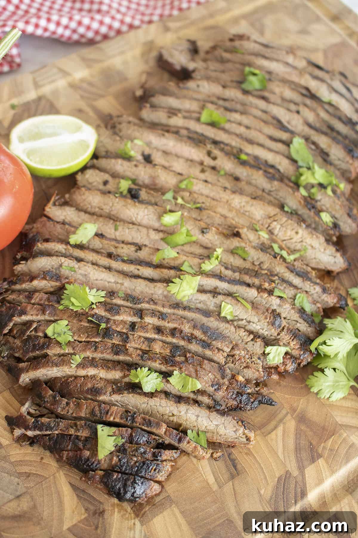 Authentic Grilled Carne Asada Recipe 3 Sliced flank steak for tacos on a cutting board.