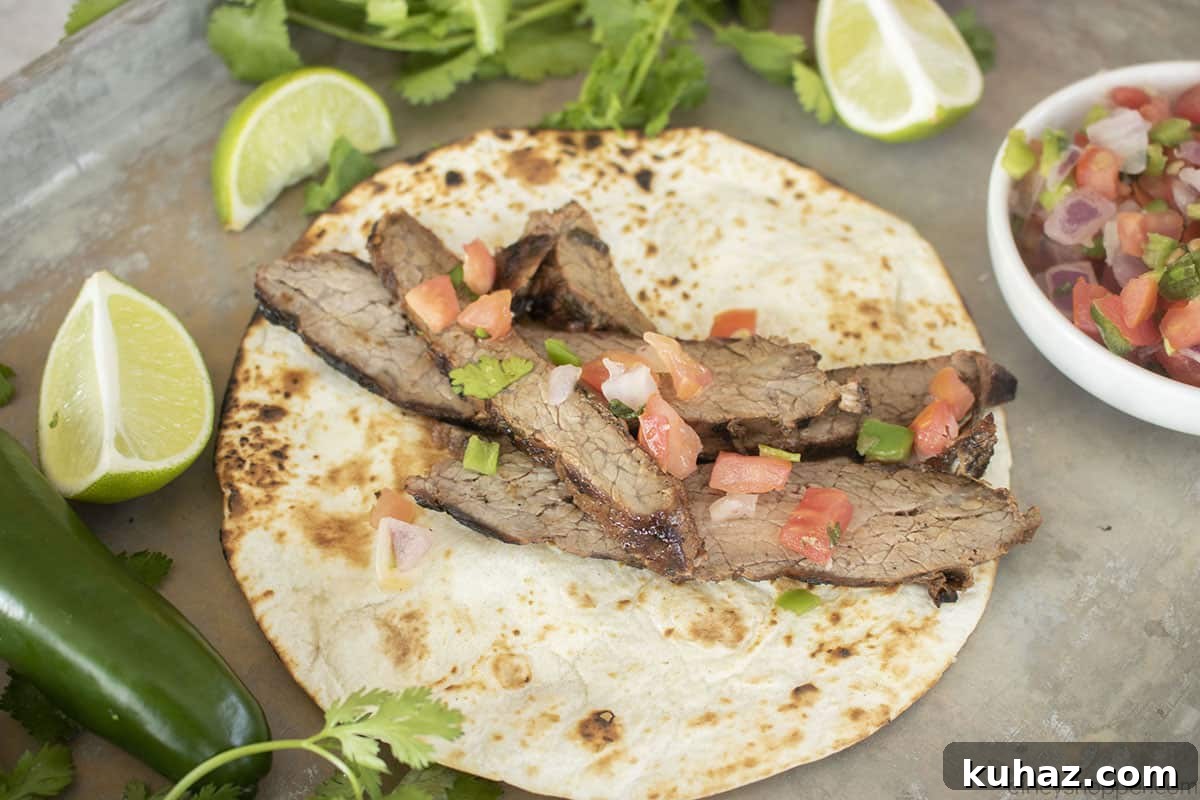 Authentic Grilled Carne Asada Recipe 6 Carne Asada with pico de gallo on a warm tortilla.