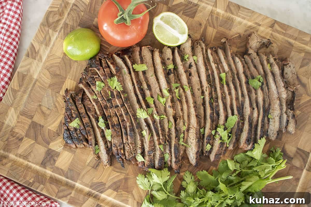Authentic Grilled Carne Asada Recipe 7 Grilled flank steak on a cutting board.
