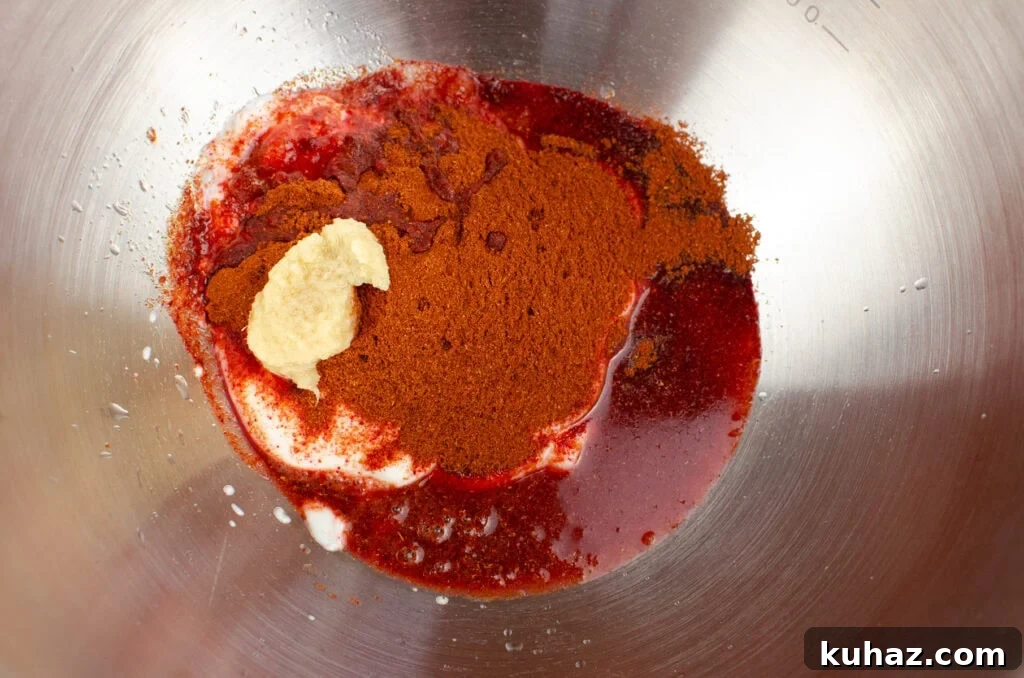 How to Make Authentic Tandoori Chicken Tikka Kebabs 4 Garlic puree, tandoori powder, yoghurt and lemon juice in a silver bowl