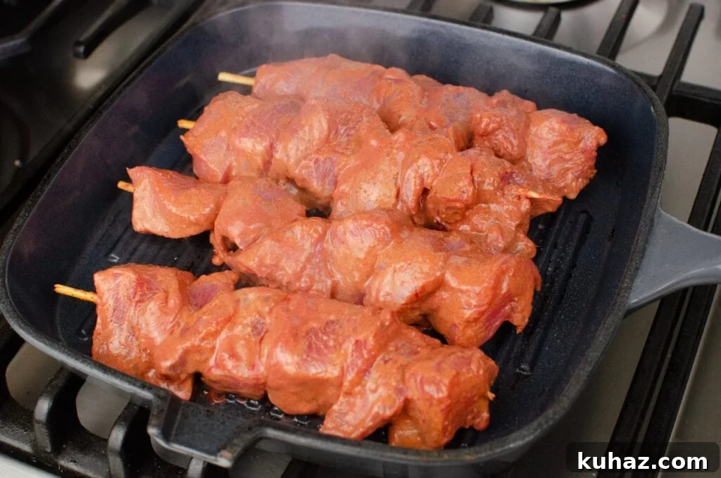 How to Make Authentic Tandoori Chicken Tikka Kebabs 12 Cooking our Tandoori Chicken Tikka Kebab on a grey cast iron griddle