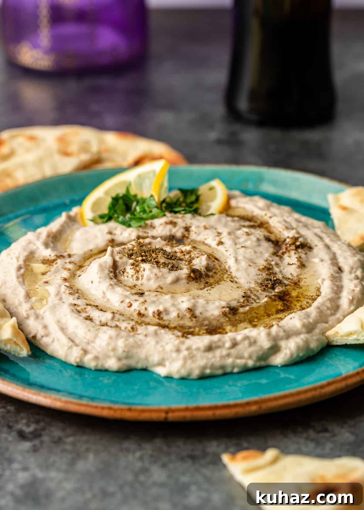 Creamy Mediterranean White Bean Hummus with Lemon and Garlic 4 my white bean hummus recipe on blue plate with garnish of lemon slices