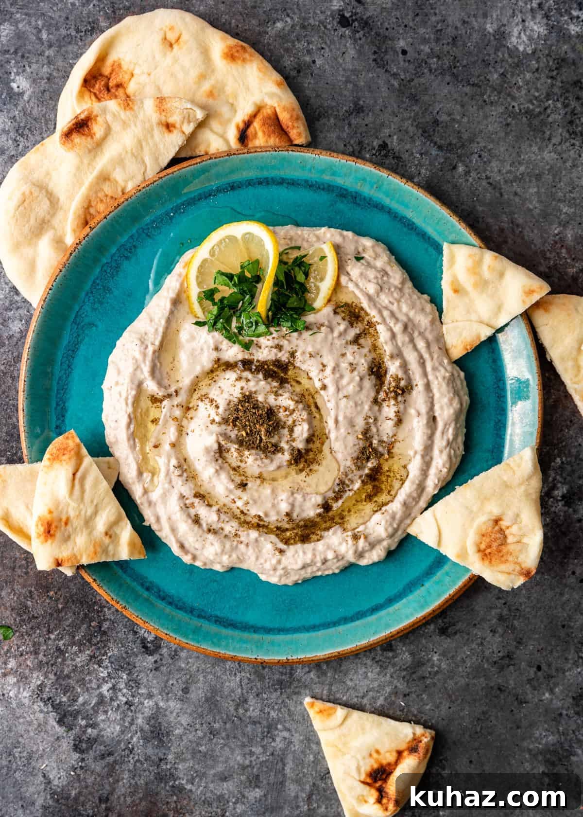 Creamy Mediterranean White Bean Hummus with Lemon and Garlic 6 overhead: white bean hummus on blue plate with pita bread triangles