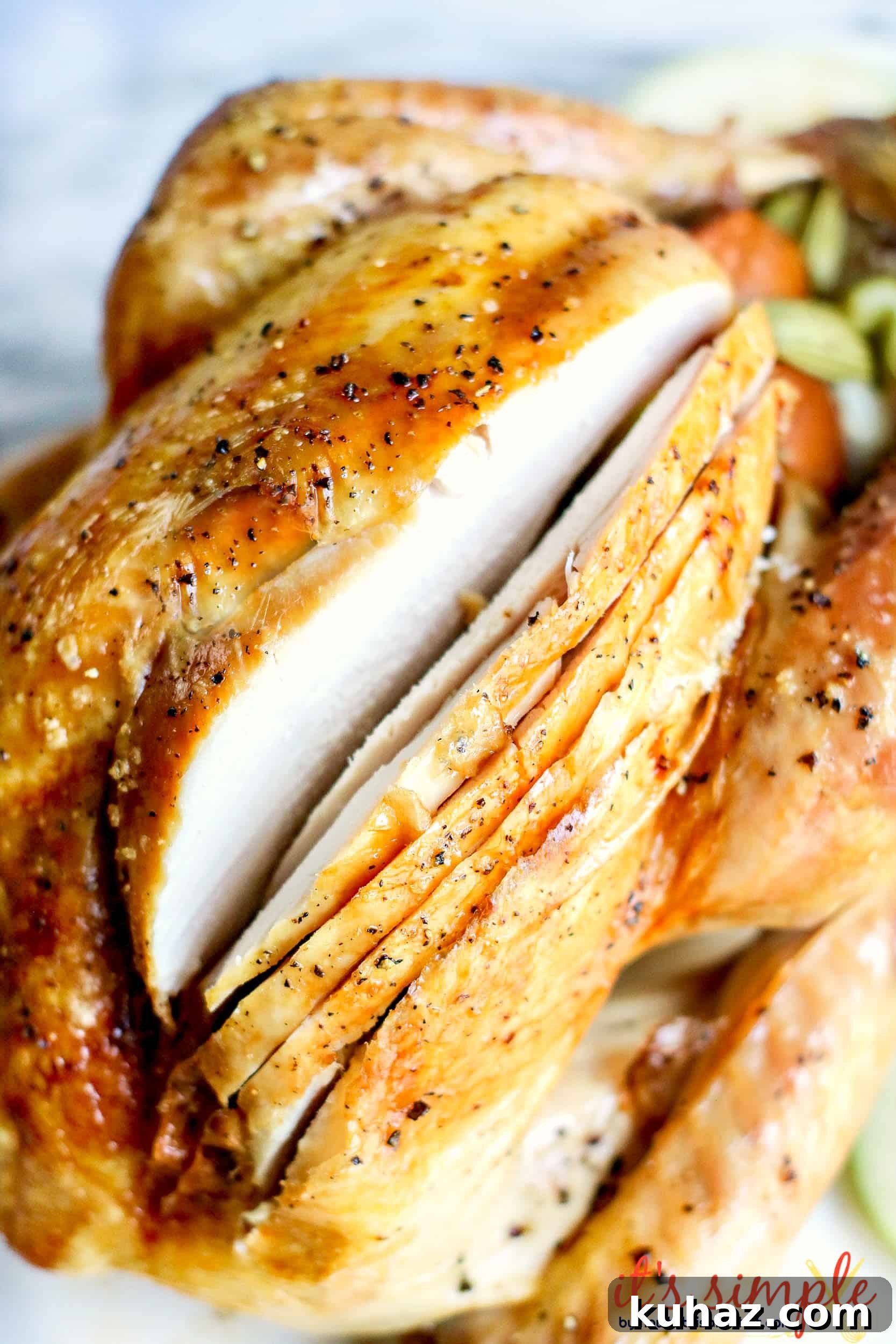 How to Roast a Whole Brined Turkey 4 whole turkey breast partially sliced on plate.