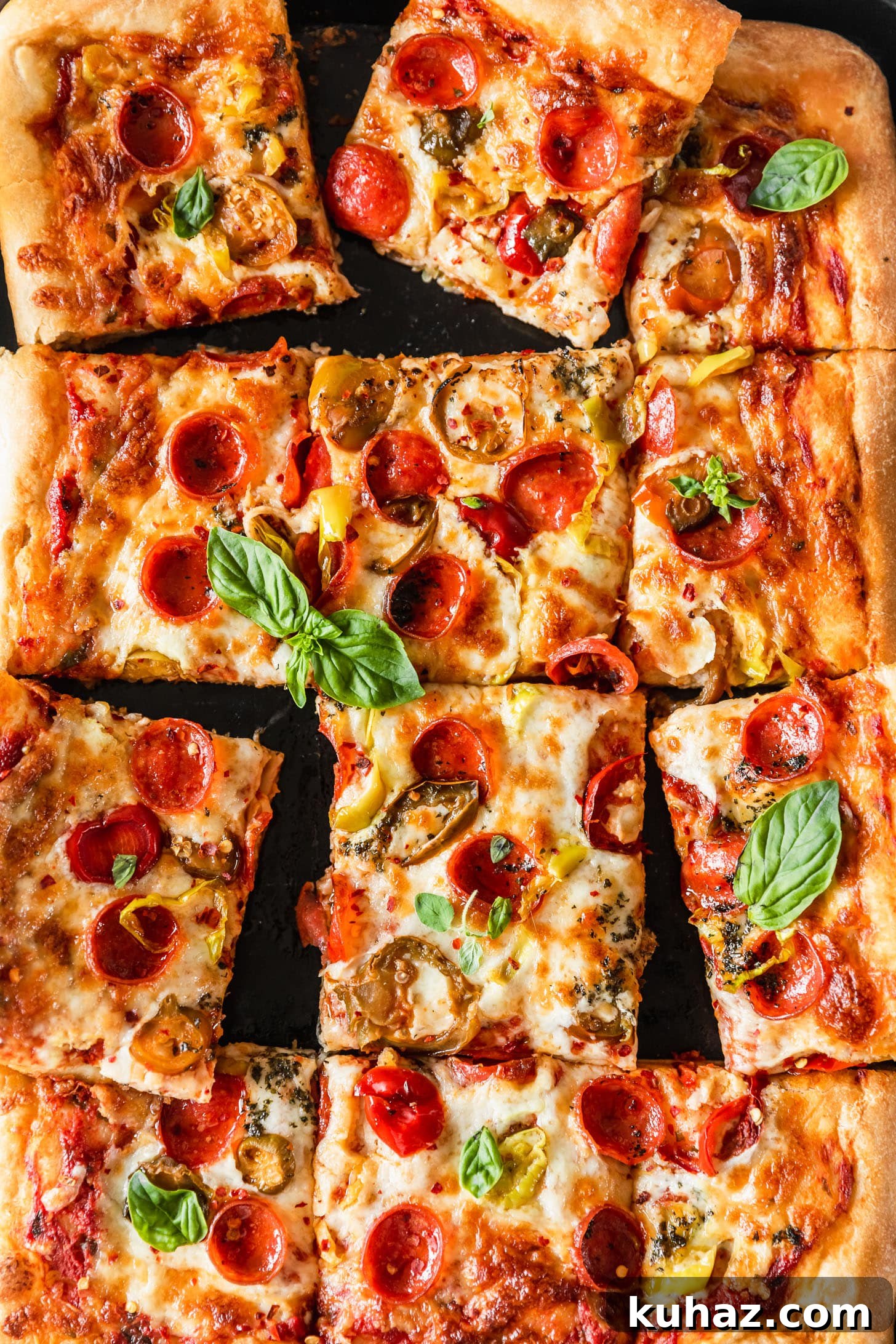 Sicilian-Style Pizza: High-Altitude Baking Tips 8 Sliced Sicilian-style pizza with pepperoni, peppers, and basil on a black sheet pan.
