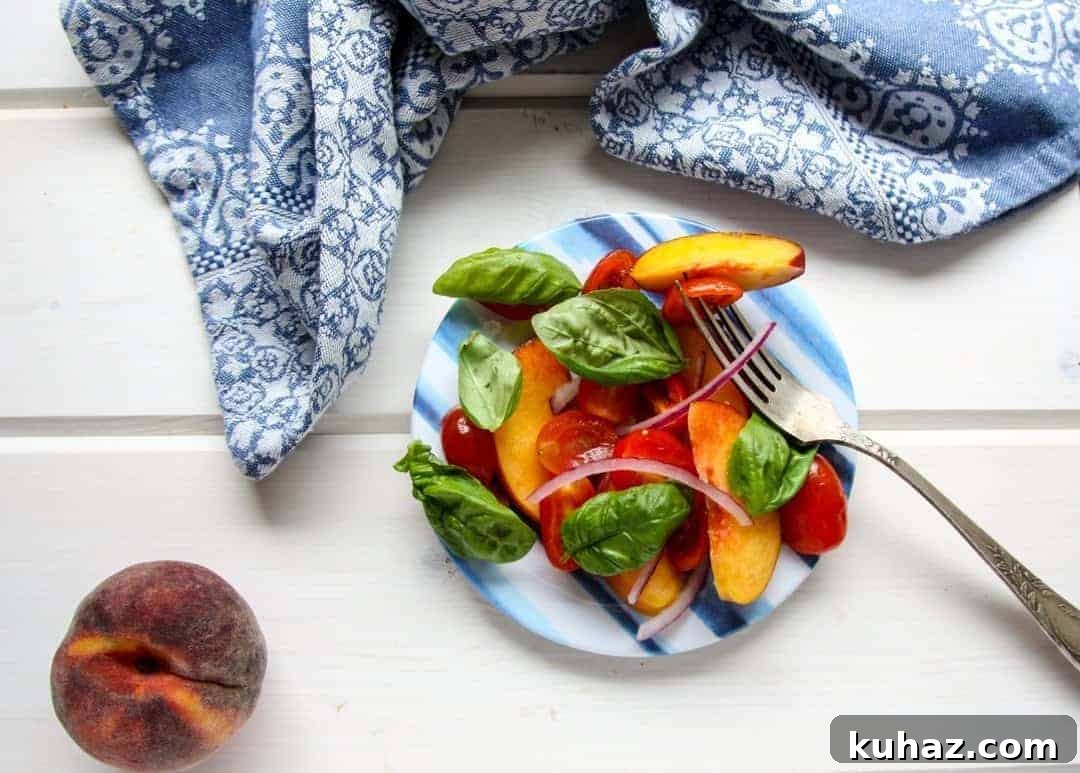 Summer Heirloom Tomato and Peach Salad with Basil Vinaigrette 7 A plate of food on a table, with Peach basil and Tomato